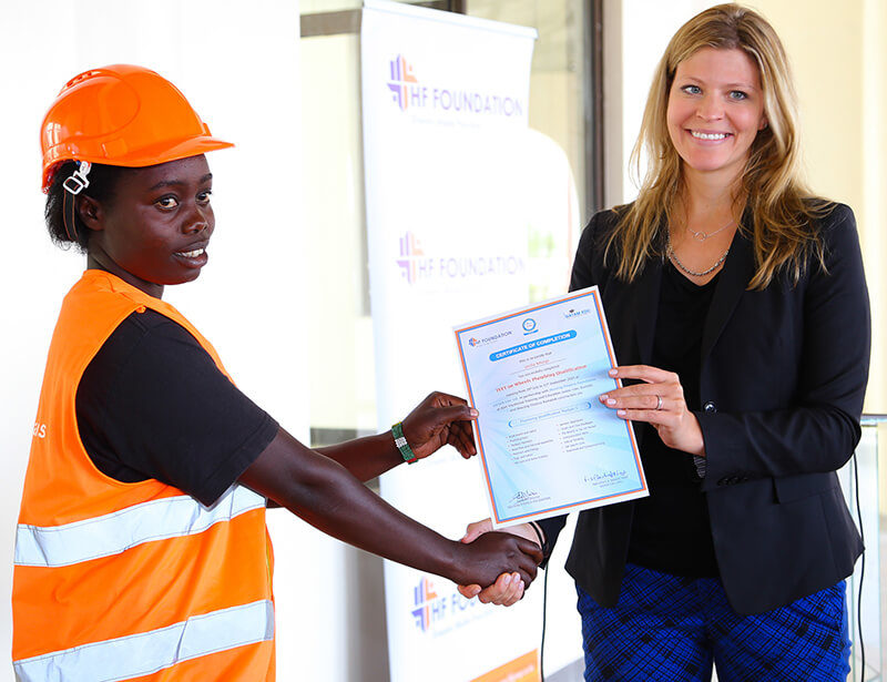 Global Communities Country Director, Kimberly Tilock presents a certificate to one the students during the Housing Finance Graduation Ceremony.