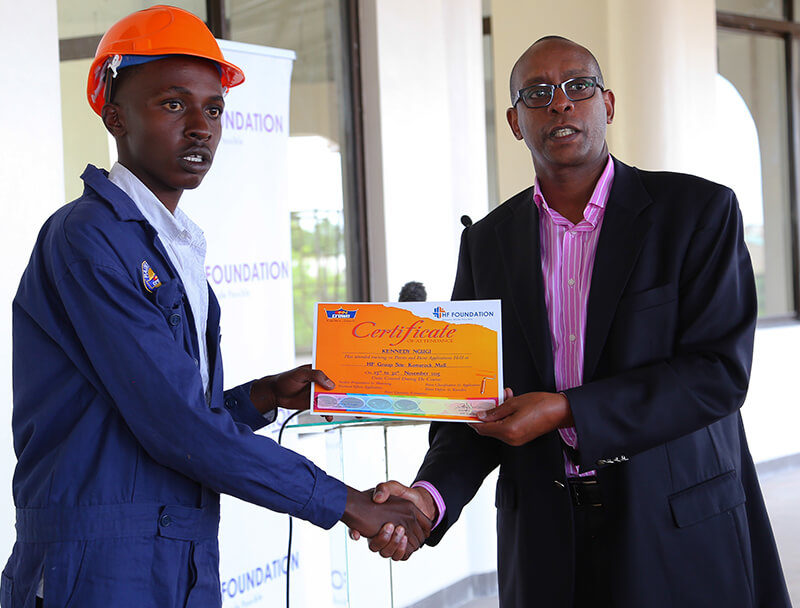 Housing Finance Group Managing Director, Frank Ireri presents a certificate to one the students during the Housing Finance Graduation Ceremony.